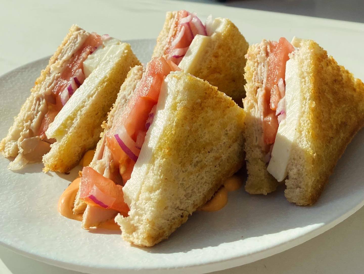 Sándwich de pollo con tomate y cebolla roja
